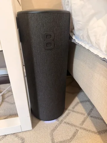 Photo from the article: the Eight Sleep hub beside the bed.